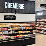 Habillage du rayon crèmerie avec lettrage LED et panneaux trompe-l'œil effet résille métallique à Saint Bonnet de Mure pour ce grand déploiement d'enseignes multi-site.